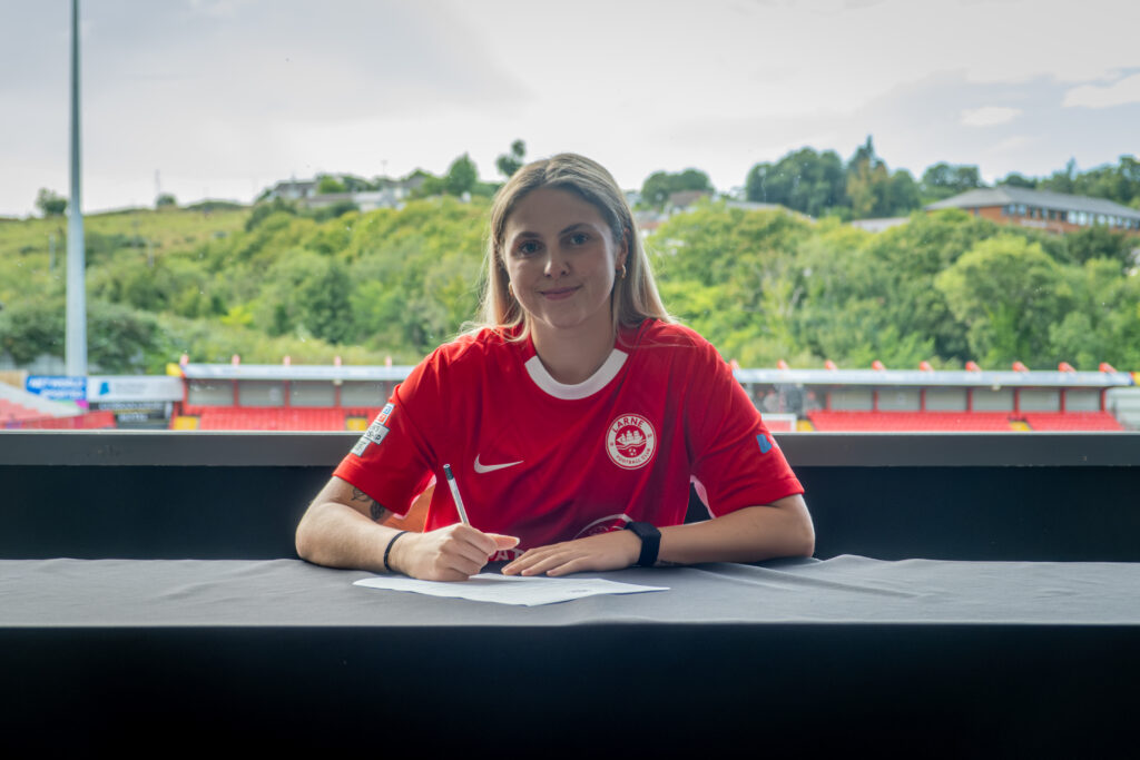 Sasha Clare signs her first professional contract